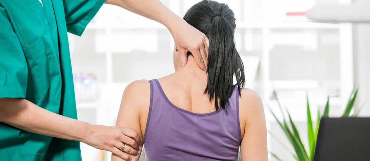 Patient with neck pain examined by a doctor